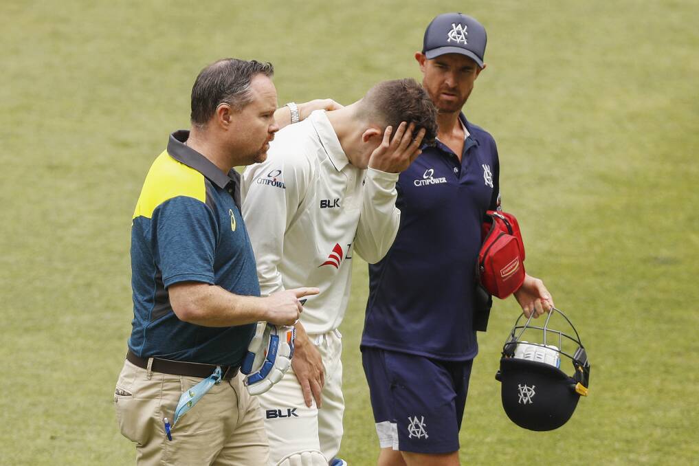 Victoria's Nic Maddinson leaves the field injured after being struck by the ball. Photo: Daniel Pockett