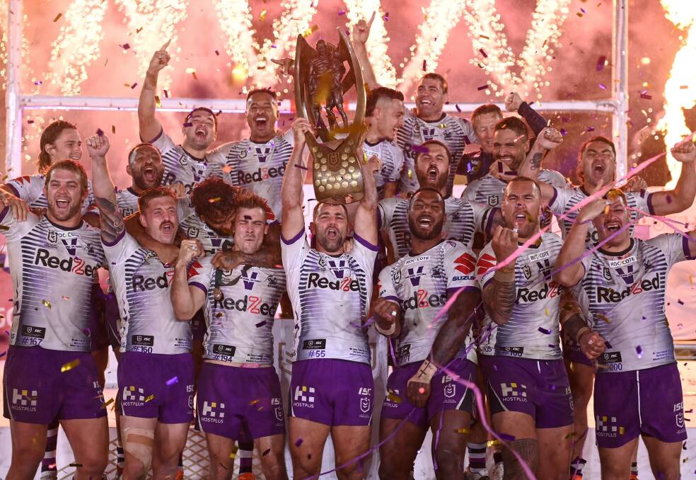Dale Finucane (top right) and his Storm side celebrate on Sunday. Photo: NRL Imagery