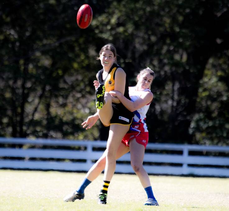 Bomaderry's India Patmore gets a kick away despite pressure from a Bulldogs defender earlier this season. Photo: Team Shot Studios