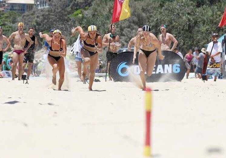 Mollymook's Kate Lewis (far right) competes in the open women's beach flags. Photo: MONKEY MYERS
