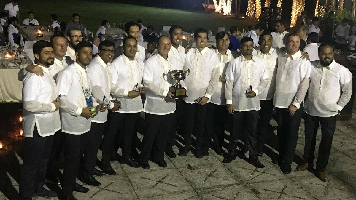 Jonathan Hill (with trophy) and his Filipino national cricket team.
