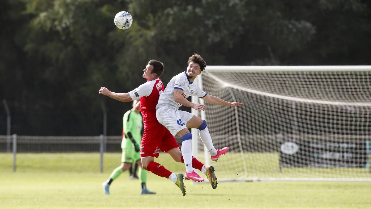 Milton-Ulladulla's Chris Price goes up for a header during Sunday's victory over Sydney Olympic. Photo: Anna Warr. 