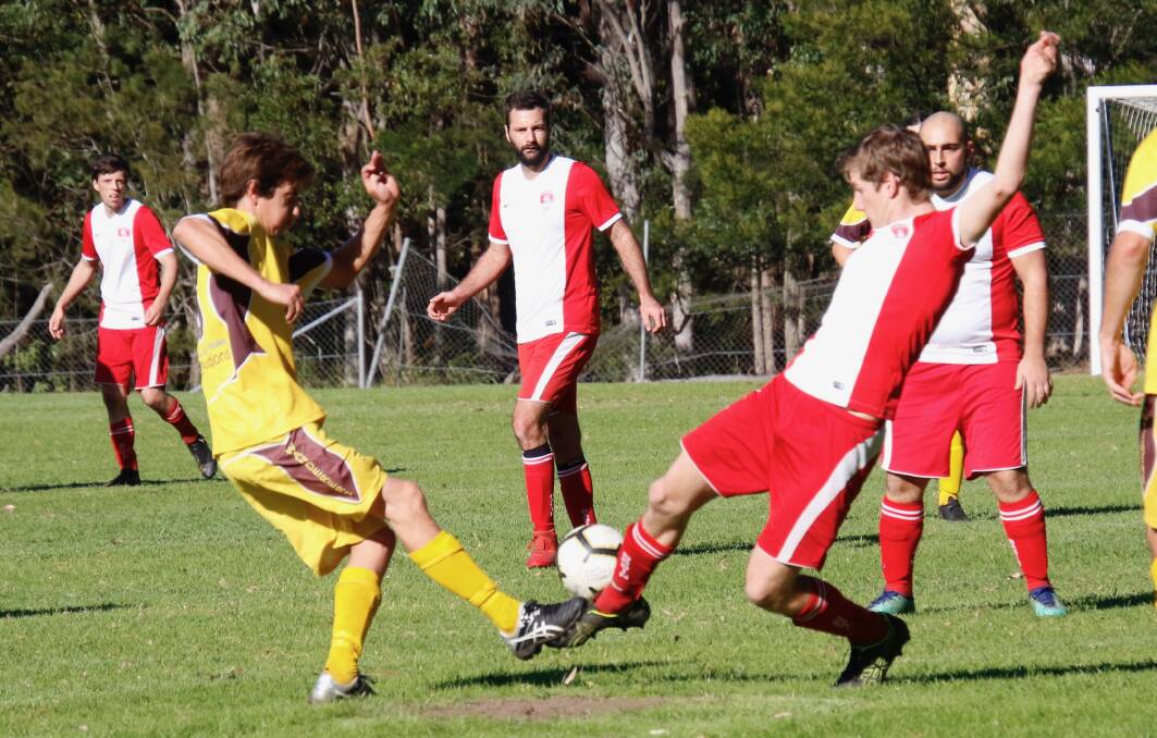 Tight match: Third grade's Blake Calderon slowing up Manyana's play in the midfield on Saturday. Basin went down 1-0.
