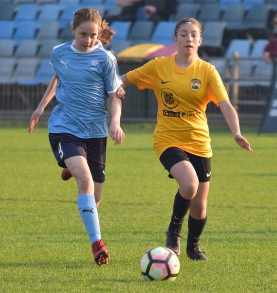 AUSSIE HONOURS: Poppy Tay (left) in action for the NSW Country under 15 girls side at last year's nationals - a tournament where she was the top scorer with 10 goals across the five days.