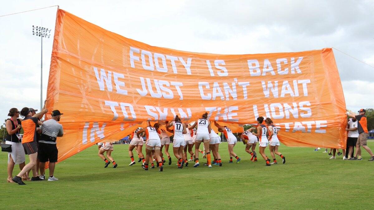 Maddy Collier and her GWS Giants run onto the field against the Brisbane Lions. Photo: GIANTS MEDIA