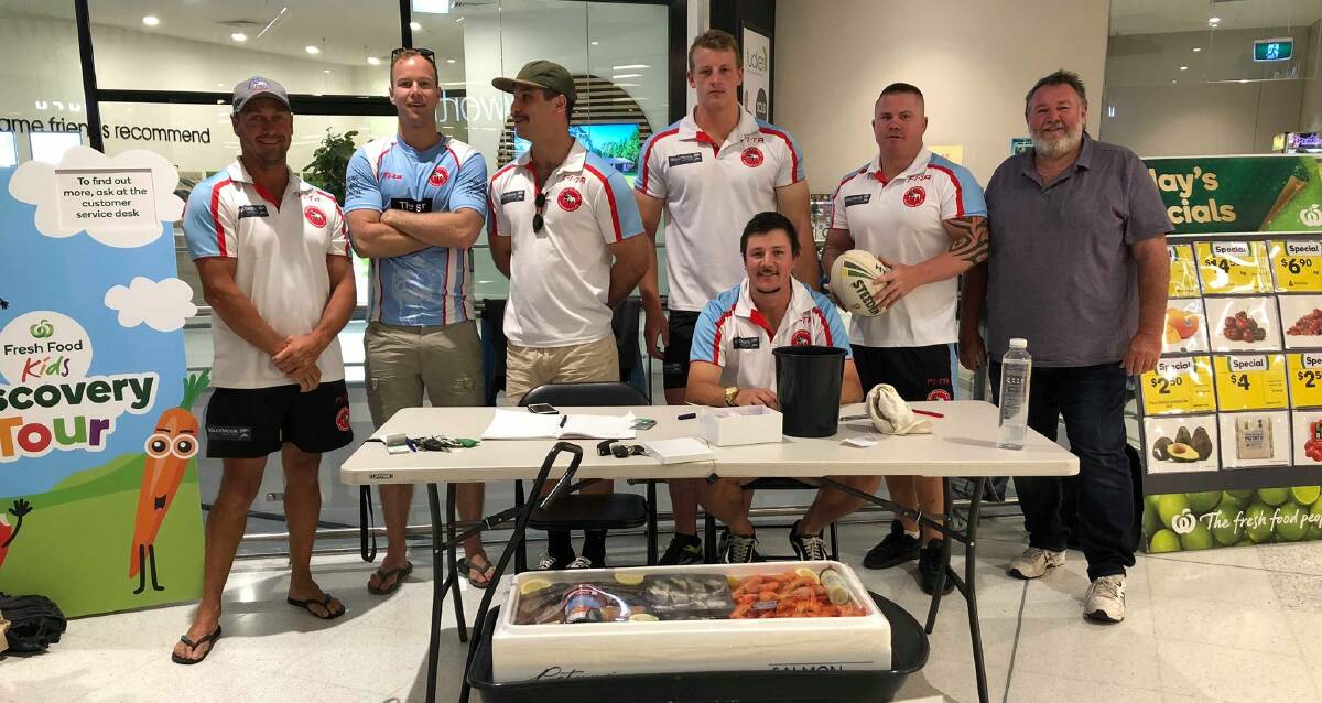 The Bulldogs players during one of their weekend meat raffles.