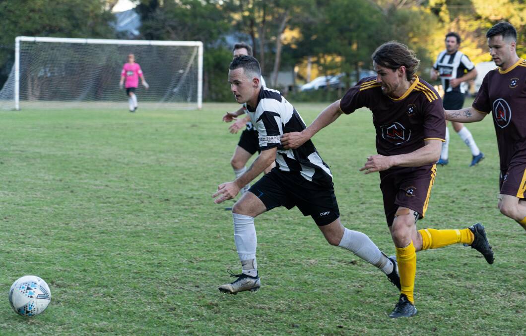 Milton-Ulladulla's Blake Mccluskey and Manyana's Tim Eastment attack the ball on Saturday. Photo: Josh Twitchen