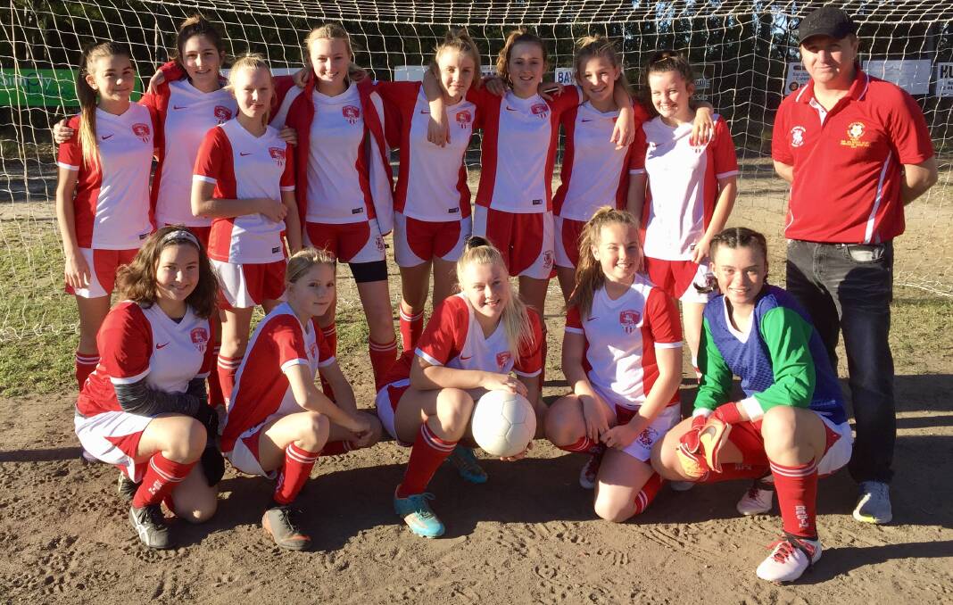 In fine form: St Georges Basin FC Under 15 girls and coach Rob Thompson have their sights set on the finals after a rocky start to the season.