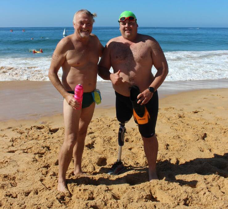 Coledale Oysters Winter Swim Club president Dave Mason with Nathan Rix after completing the Tilbury Classic. Photo: JULIE LAWRENCE