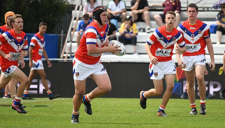 Gerringong's Kane Graham takes a hit-up for the Dragons, while fellow Lions Wes Pring and Noah Morphett watch on. Photo: NSWRL
