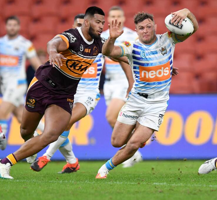 Gold Coast's Mitch Rein tries to avoid being tackled by Brisbane's Payne Hass. Photo: NRL Imagery/Scott Davis