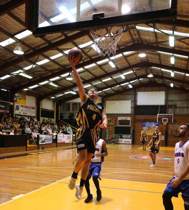 Billy Campbell goes up for a lay-up for the Tigers in 2019. Photo: Robert Crawford