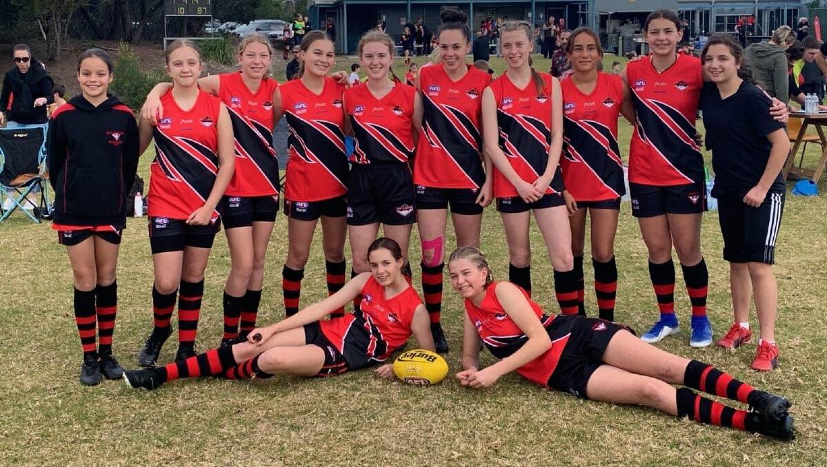 BIG FUTURES: Bay and Basin Bombers under 15 girls side are all smiles prior to their recent round one match.