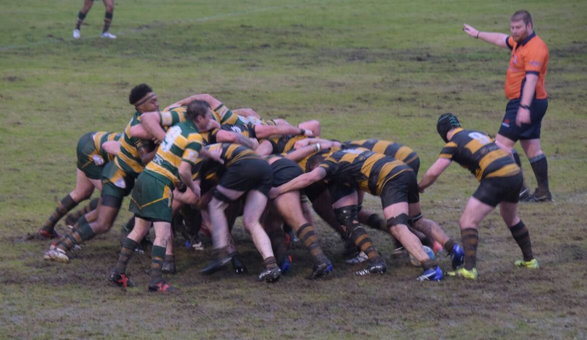 Shoalhaven and Camden pack down during a muddy scrum on Saturday. Photo: Courtney Ward