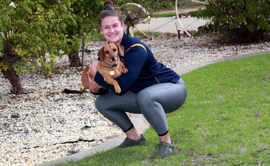 ACT Brumbies hooker Harriet Elleman has been using dog Waffles to help train during the lockdown. Picture: Les Smith