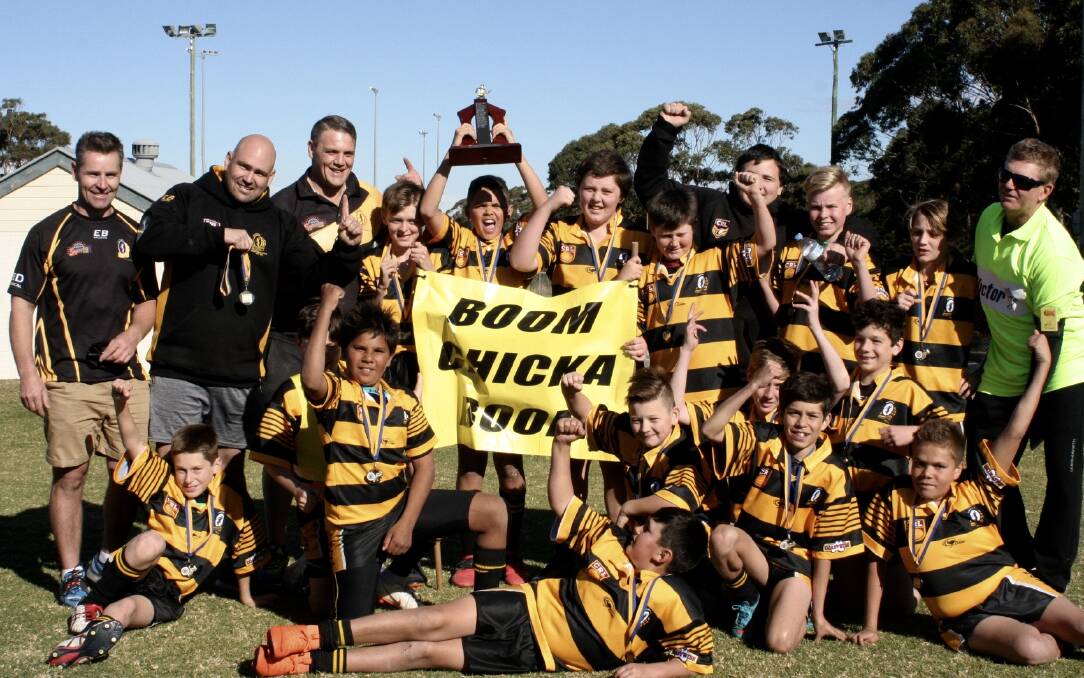 2018 Premiers: The Under 12-2 Nowra Warriors celebrate with coach Sean Cruickshank after their 20-12 win over St Georges Basin.
