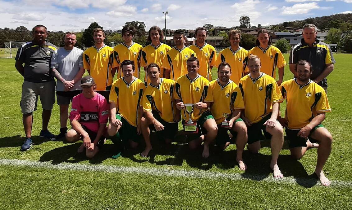Nathan Aldridge (left) and his Shoalhaven men's football team after claiming their second straight branch title.