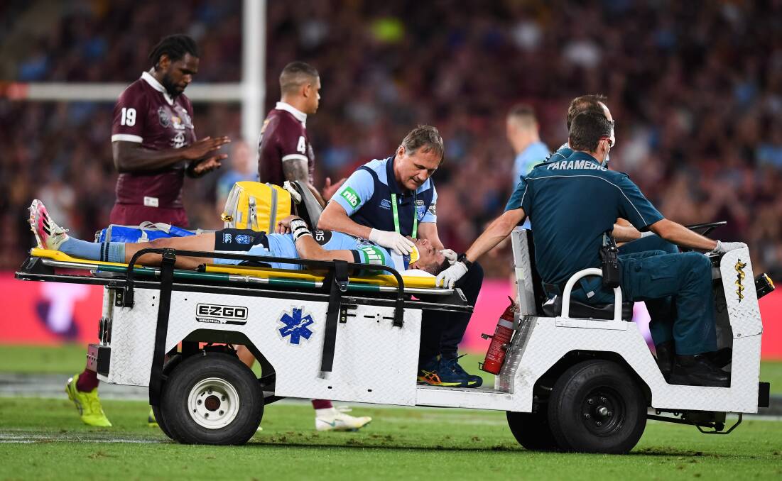 Cody Walker leaves the field on a medicab on Wednesday night. Photo: Nathan Hopkins/NRL Imagery