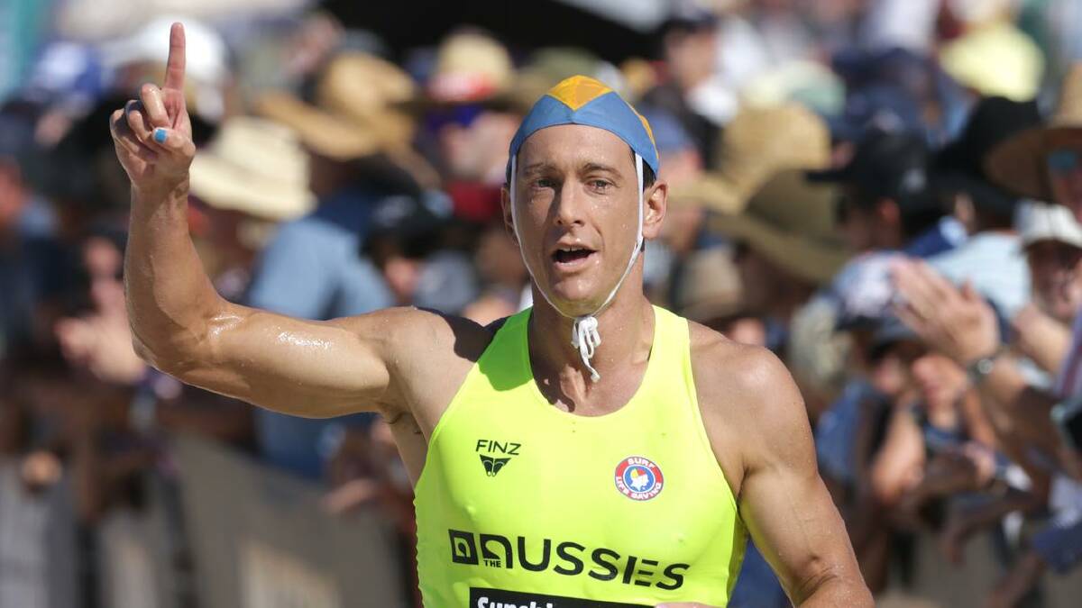 Ali Day crosses the line in first to secure his maiden Australian ironman title at the Sunshine Coast. Photo: SLSA