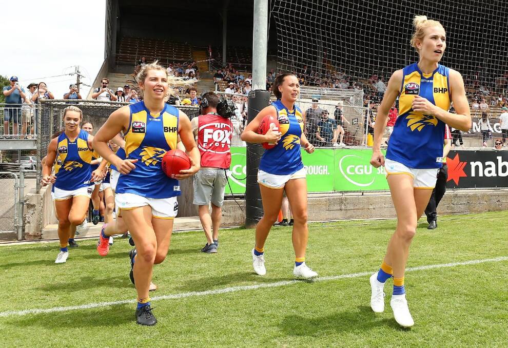 Maddy Collier (front left) and her West Coast side run onto the field during the 2020 AFLW season. Photo: Eagles Media