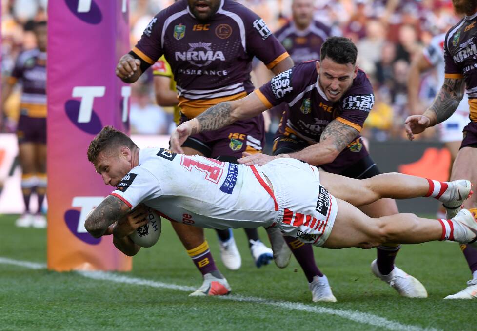 Dragons' Tariq Sims dives over to score a try against the Broncos. Photo: DAVE HUNT