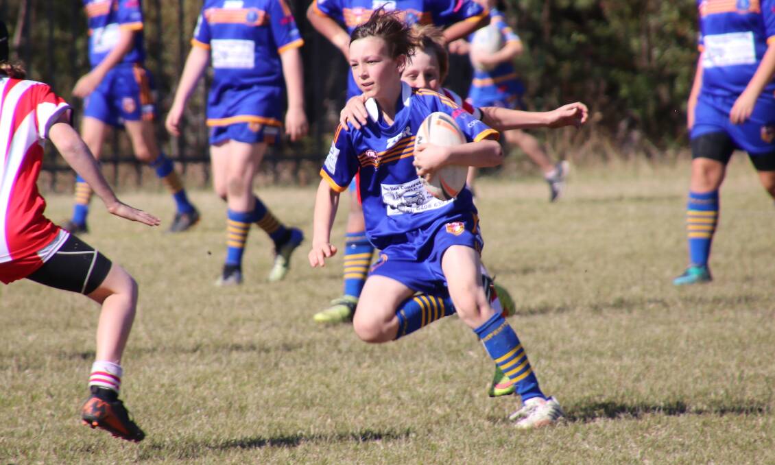 Tough game: Bomaderry under 12s player Aaron Hughes prepares to evade the defence in the match against St Georges Basin last weekend.