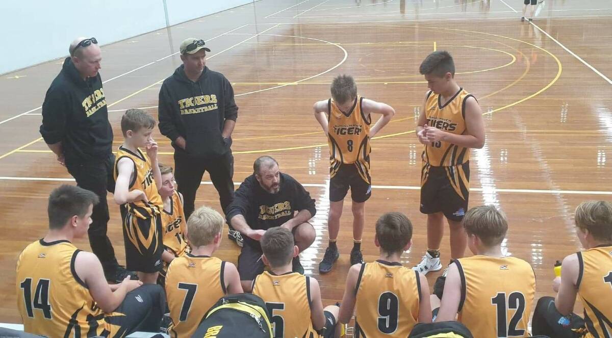 Luke Royston chats to his Shoalhaven under 14 boys division one side during a huddle at the Illawarra Sports Stadium. PhotoL Supplied