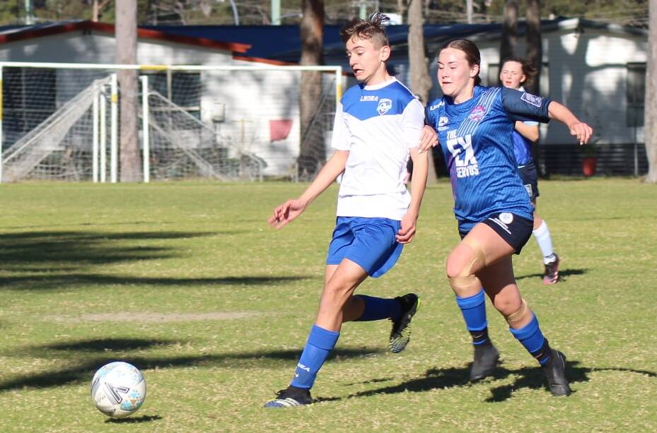 Southern Branch Inc's George Hyam and South East Phoenix's Ella Churchill contest possession on Sunday at Ison Park. Photo: Tracy Mandavy