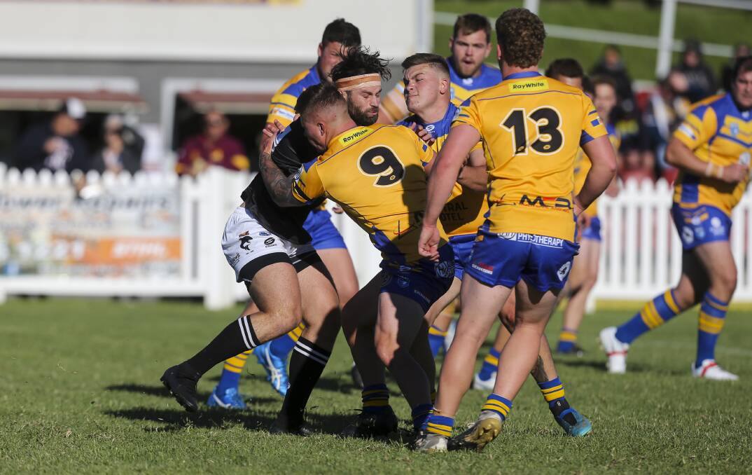 Dean Hodgson (centre) and his Gorillas teammates make a tackle on Sharks' Declan Morrissy in round one. Photo: Anna Warr