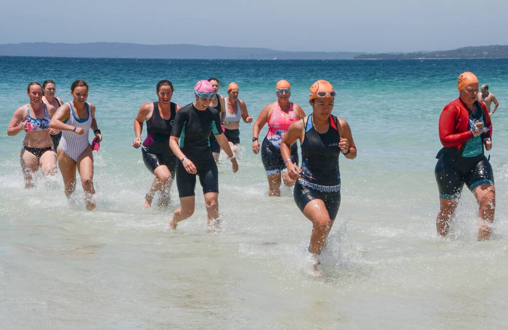 TOUGH CUSTOMERS: Women competitors exit the water during the super sprint race, at the Callala Triathlon Festival on Saturday. Photo: Ian Moore