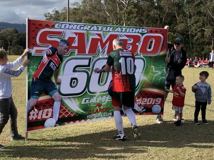 Sam Leedham runs through a banner in his 600th senior game for Illaroo. Photo: SUPPLIED