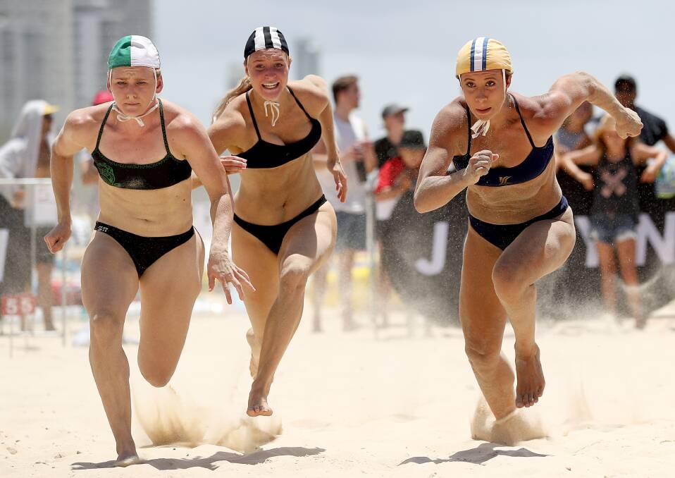 Mollymook's Kate Lewis (centre) competes in the open women's flags. Photo: SHANE MYERS