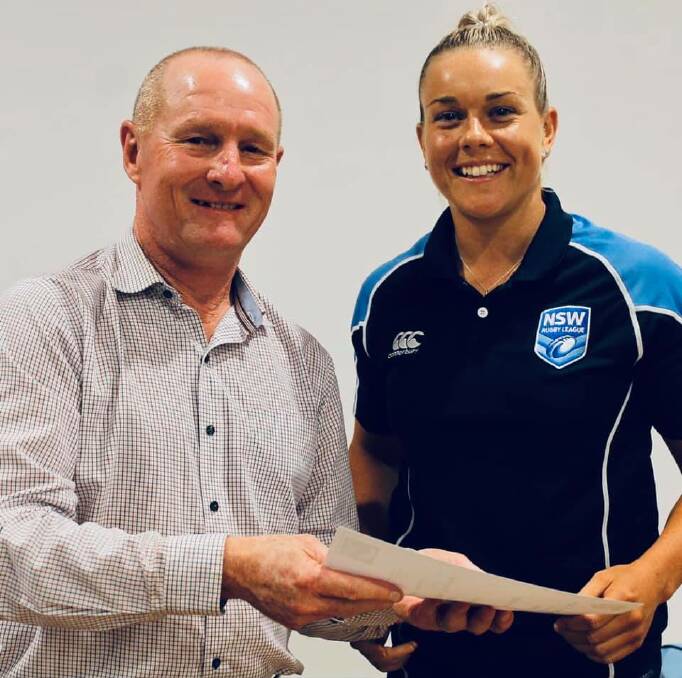 NSW Referees life member Michael Lewis presents Karra-Lee Nolan with her NSWRL Referees Association member number of 1018. Photo: NSWRL