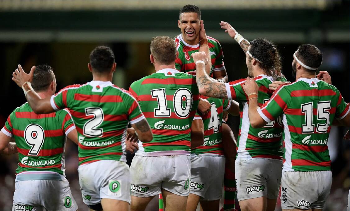 Rabbitohs players rush in to congratulate five-eighth Cody Walker after his second-half try. Photo: AAP