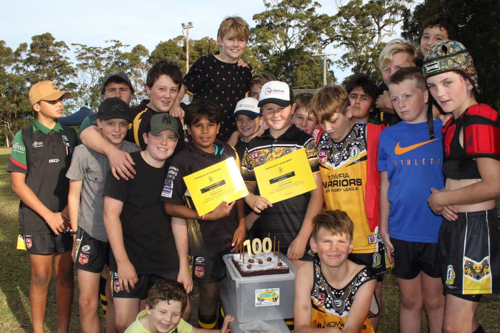 Milestones: Jack Langford and Cohen Langlo, who both marked their 100th game for Nowra Warriors in the match agains St Georges Basin, surrounded by team-mates.