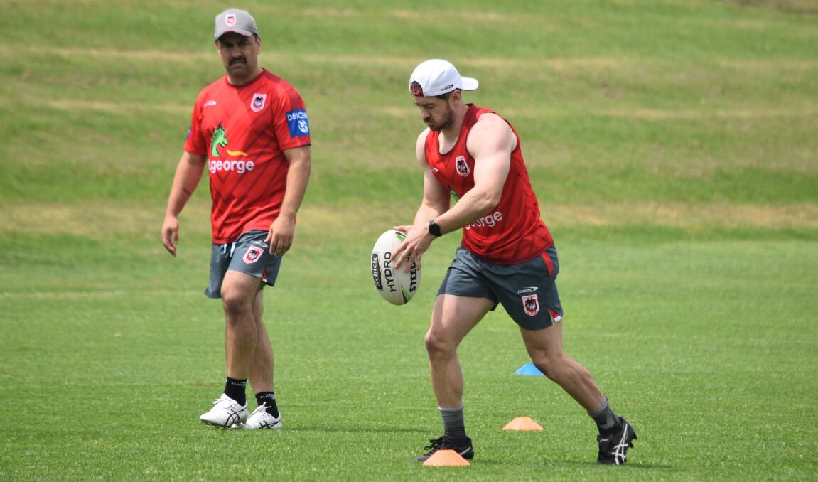 Adam Clune practices his kicking as coach Jamie Soward watches on. Photo: Dragons Media