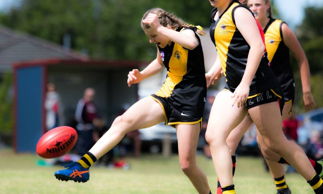 Bomaderry Tigers' Lily Robinson kicks the ball during the 202 AFL South Coast season. Photo: Team Shot Studios