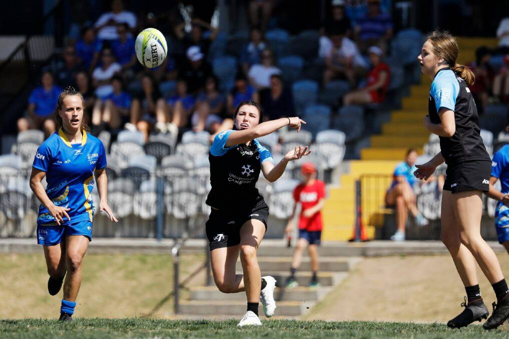 University of Canberra's Lily Murdoch passes as Aroha Spillane looks on. Photo: Karen Watson/Rugby AU Media