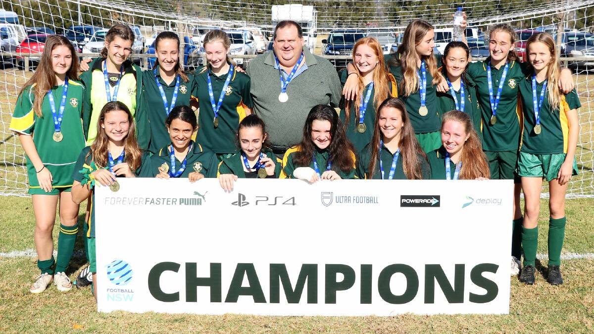 WINNERS: The Shoalhaven under 16s girls football side, with their coach Brad Banks, after their Country Cup victory.