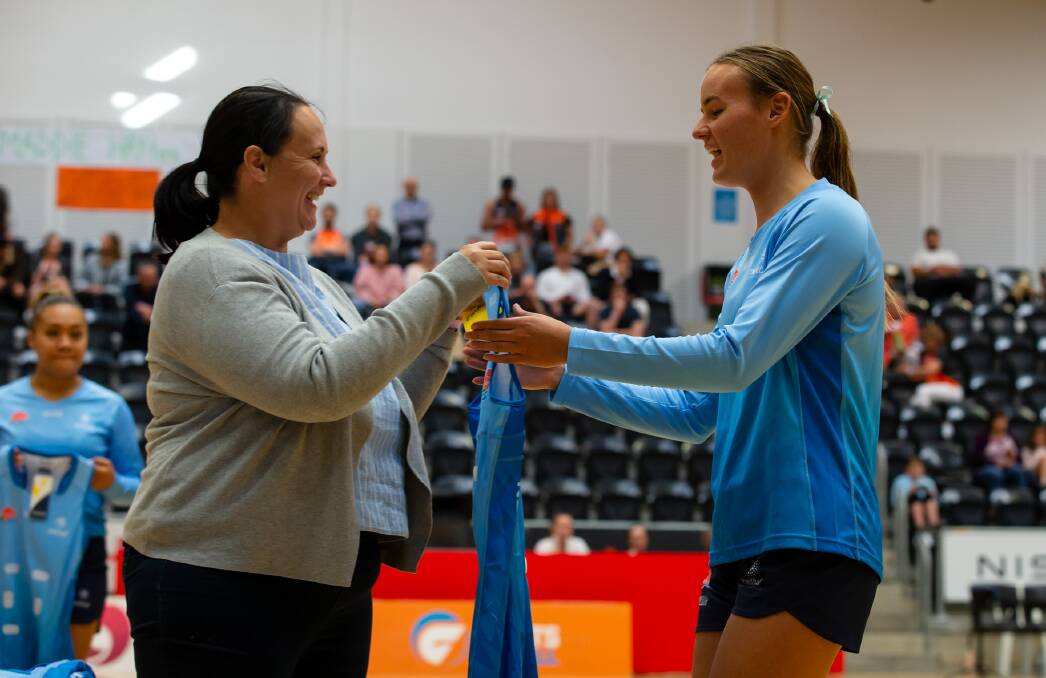 Emma Keane being presented her NSW state uniform by the chair of Netball NSW Louise Sullivan. Photo: Netball NSW