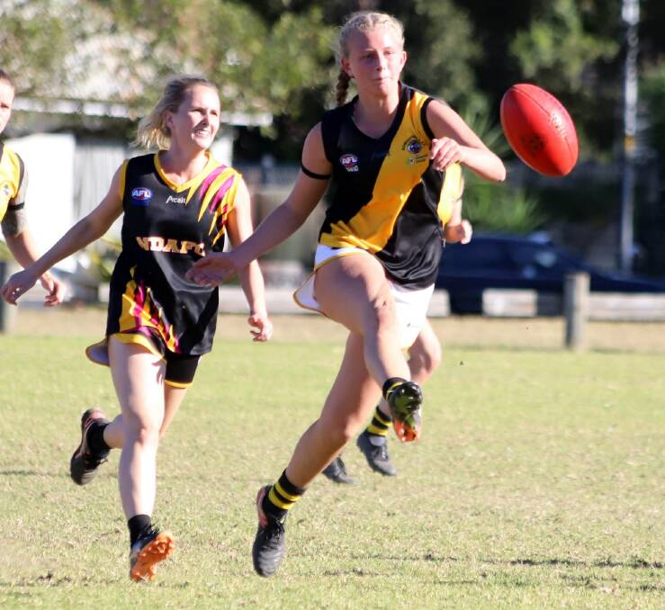 PRODIGY: Cambewarra's Sophie Phillips kicks to a Bomaderry Tigers team mate during a recent AFL South Coast fixture against Northern Districts. Photo: TEAM SHOT STUDIOS