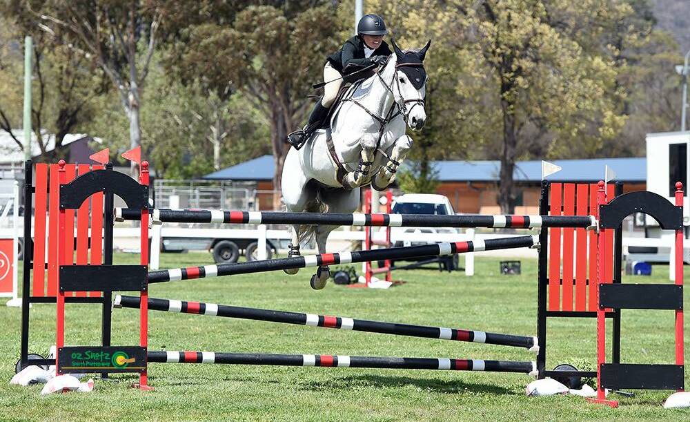 Jamie Priestley and Courage competing during the NSW Showjumping Championships. Photo: Oz Shotz
