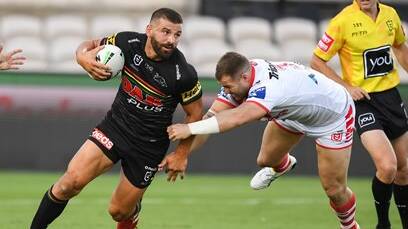 Penrith's Josh Mansour avoids being tackled by St George Illawarra's Trent Merrin on Friday. Photo: DRAGONS MEDIA