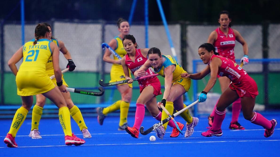 Hockeyroos' Kalindi Commerford tries to win possession for her team against Japan. Photo: HOCKEY AUSTRALIA