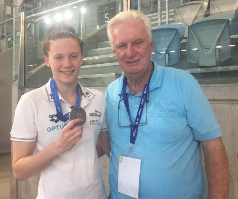 Jasmine Greenwood shows off her silver medal with coach Bob McEvoy.