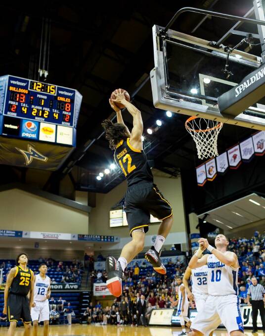 Winthrop's Xavier Cooks skies for a slam dunk. Photo: JOEL CRIMM PHOTOGRAPHY