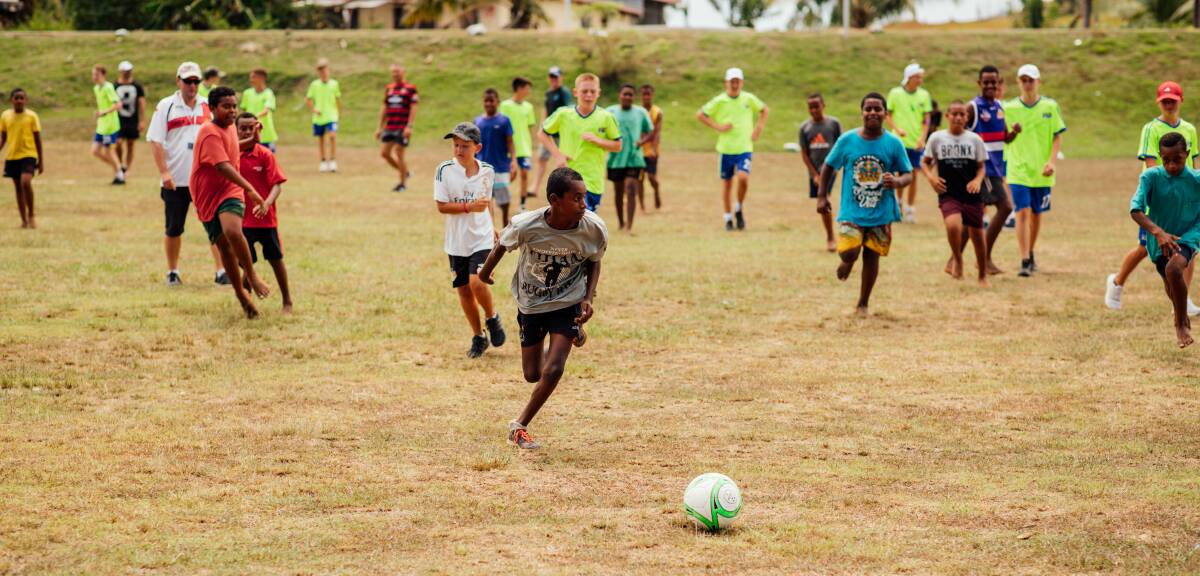 IFG NSW players enjoying a kickabout game with Fijian villagers. Photo: Supplied