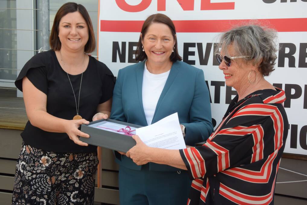 Eden-Monaro MP Kristy McBain and Gilmore MP Fiona Phillips receive the petition from cancer survivor Catherine Hurst on behalf of the wider community. 