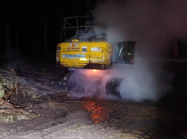 CRIME SCENE: One of the excavators set alight at St Georges Basin early Monday morning. Photo: RFS St George Basin