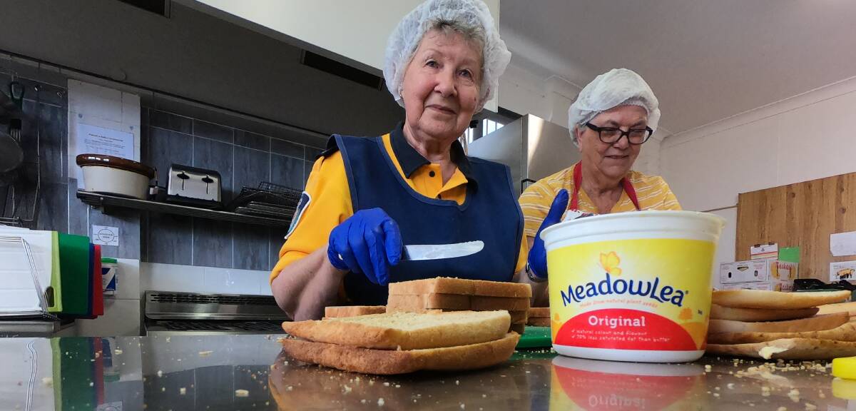 ASSEMBLY LINE: Beth Wares from Culburra Beach and Jill Lea from Milton butter bread for sandwiches. 